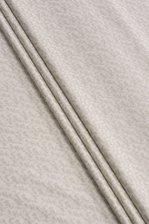 Tejido jacquard beige con tobillos