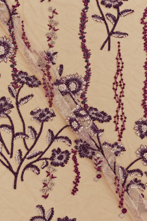 Embroidered tulle with richly decorated floral motifs