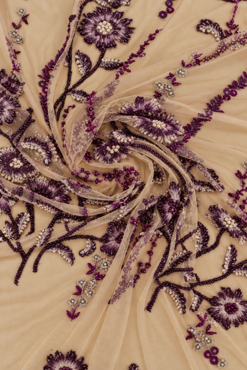 Embroidered tulle with richly decorated floral motifs